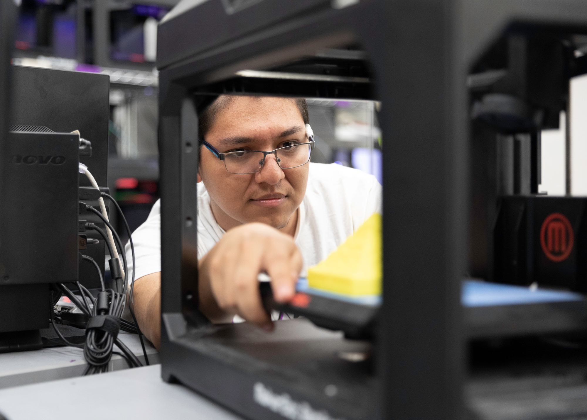 Student working on 3D printer.