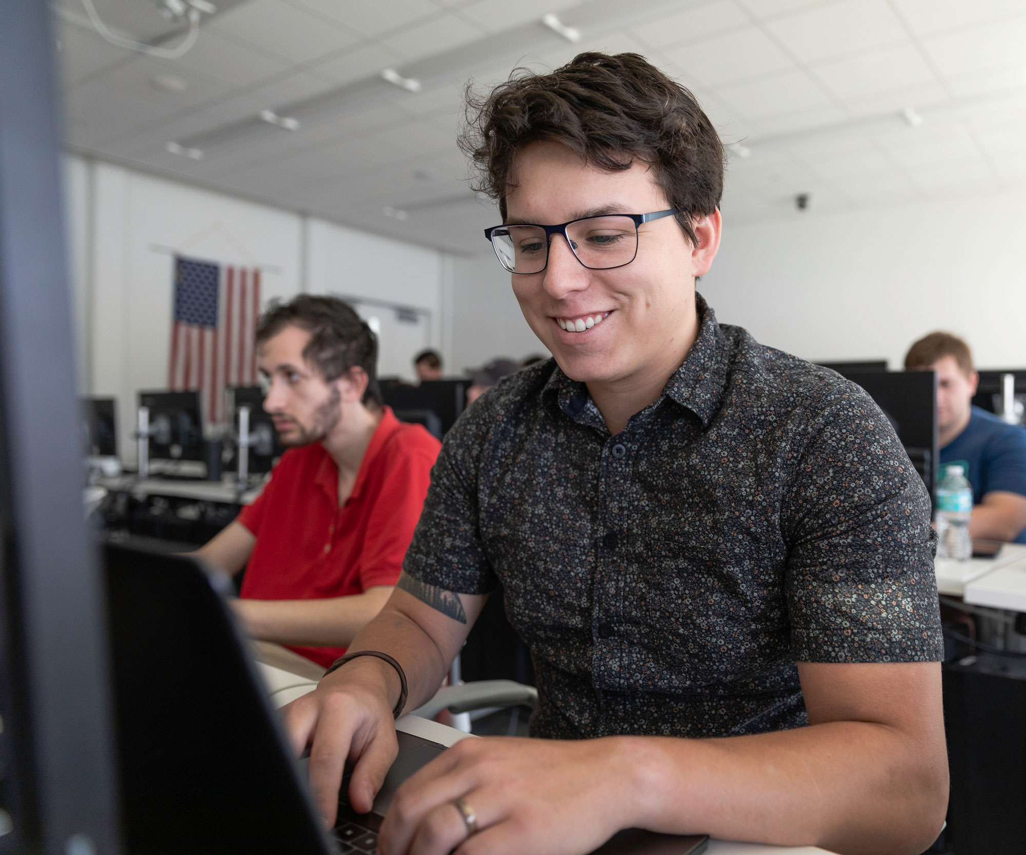 Light skinned male at a computer.