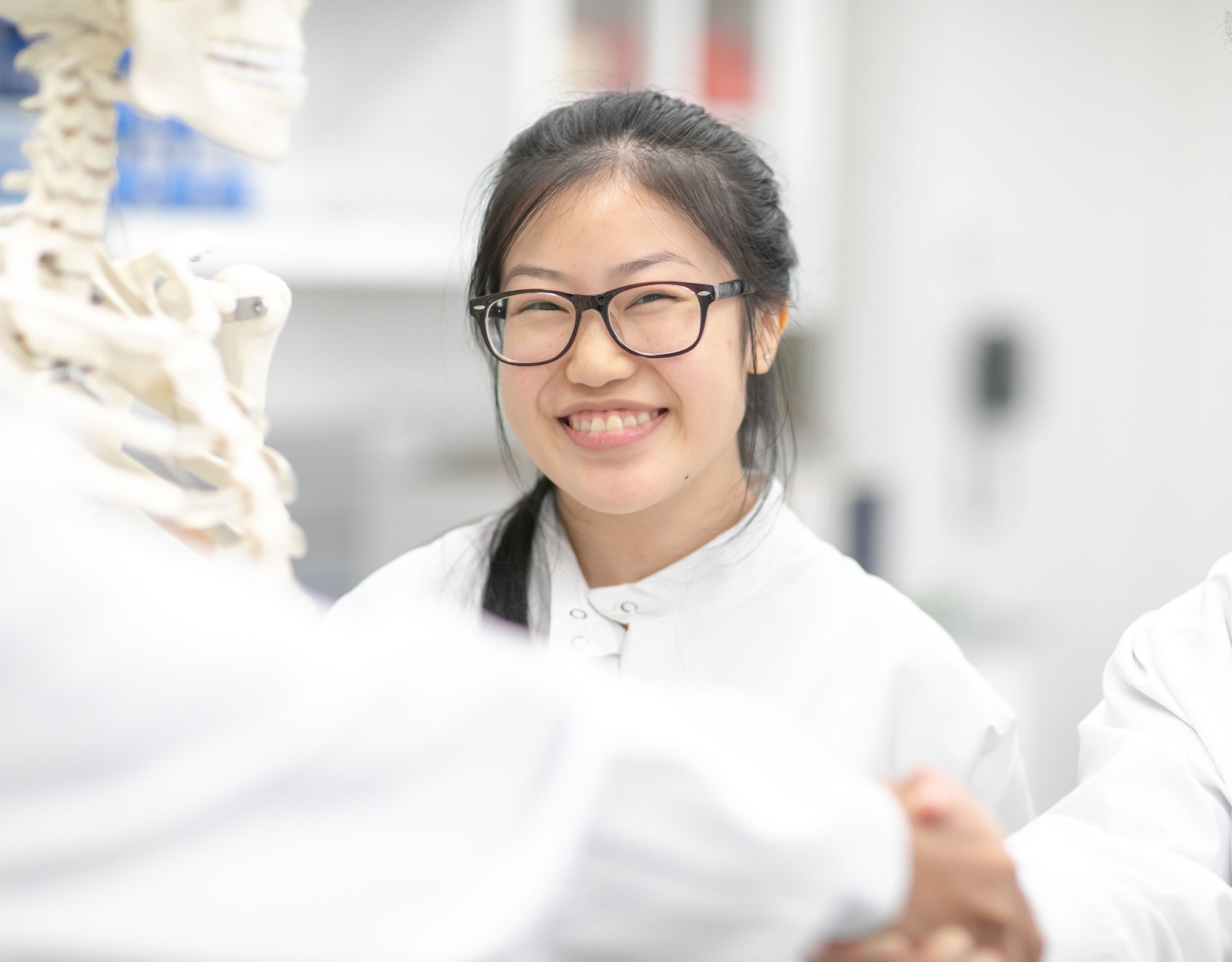 Light skinned female in a lab coat.