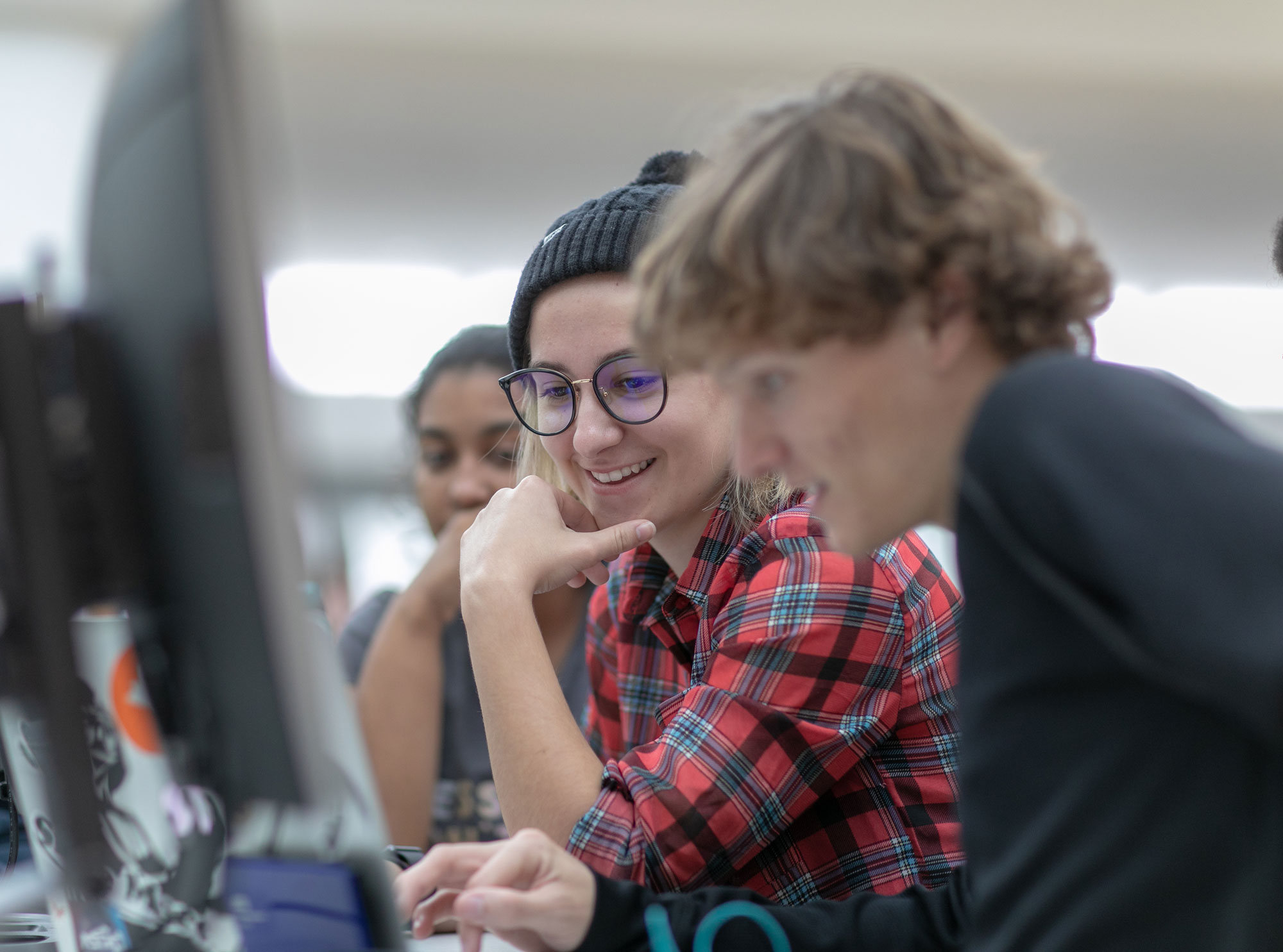 Group of students looking at a computer.