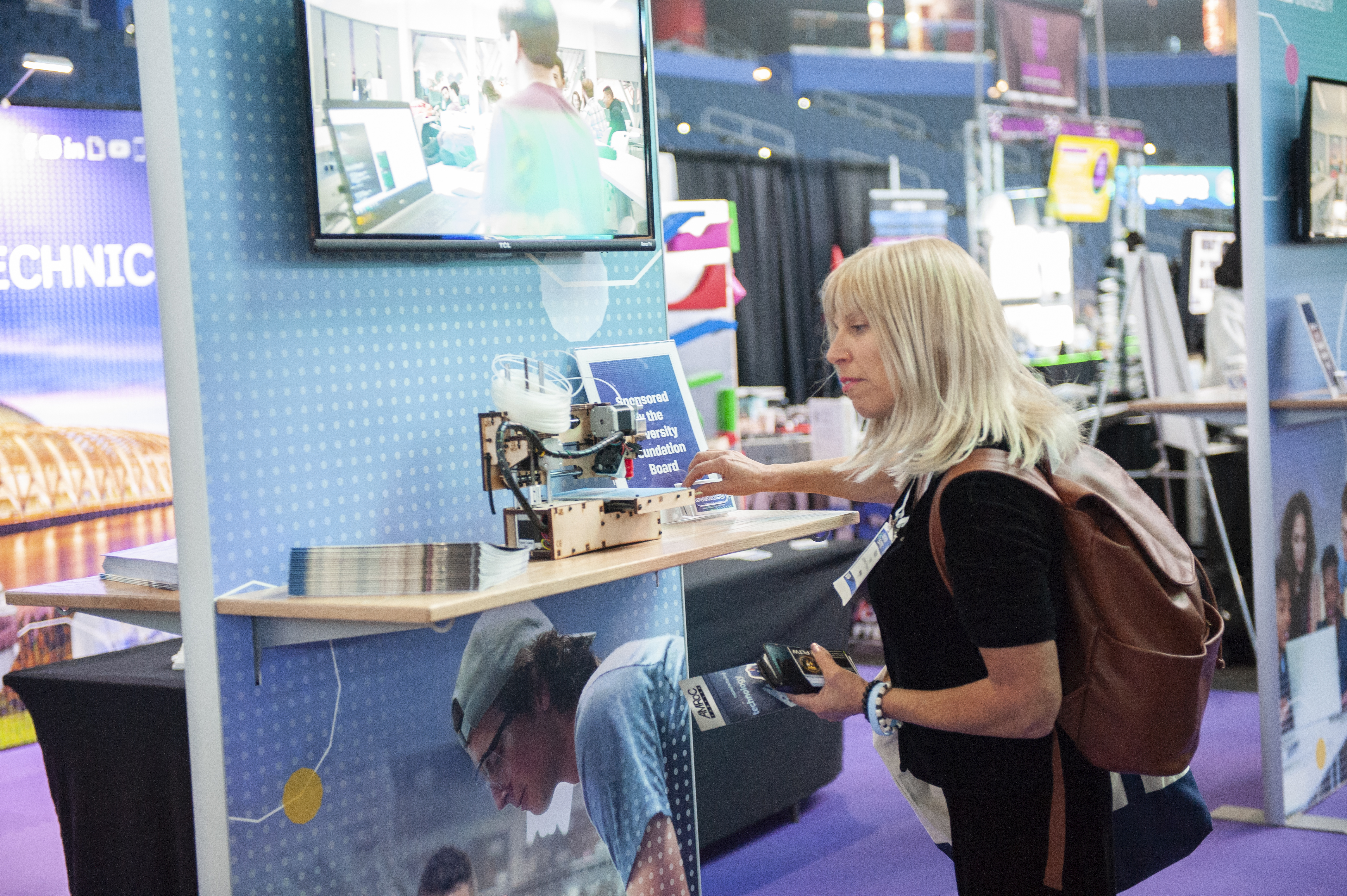 A woman looking at a student experiment.