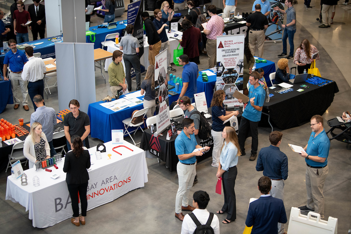 Students talking with employers at a career fair.