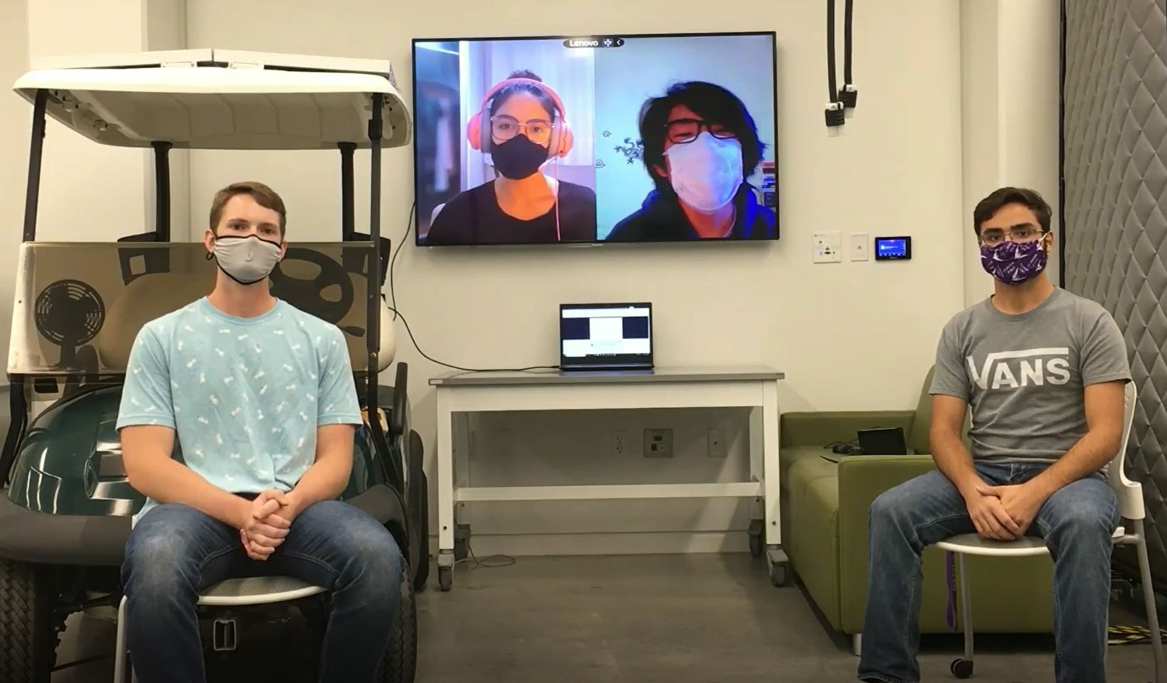 Students sitting down with masks on.