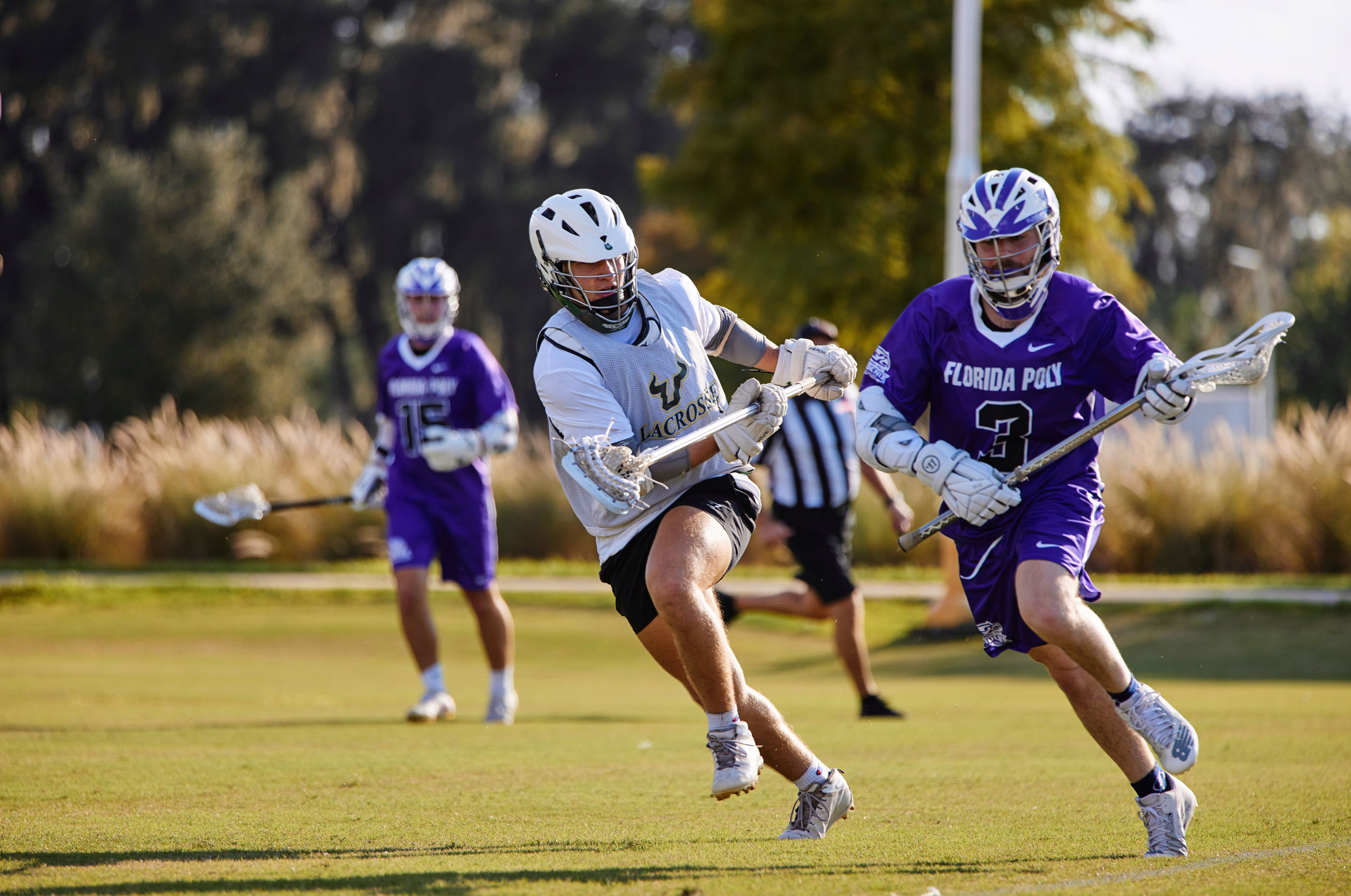 Florida Polytechnic University student Jack Koziel gets past a defenseman from the University of South Florida Division I lacrosse team.