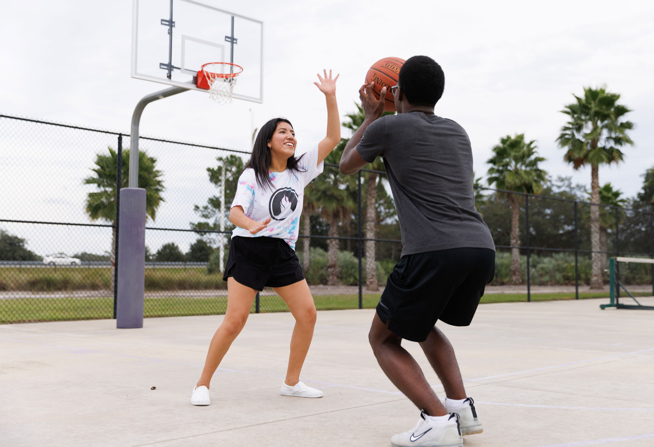 Two students play basketball at Florida Polytechnic University