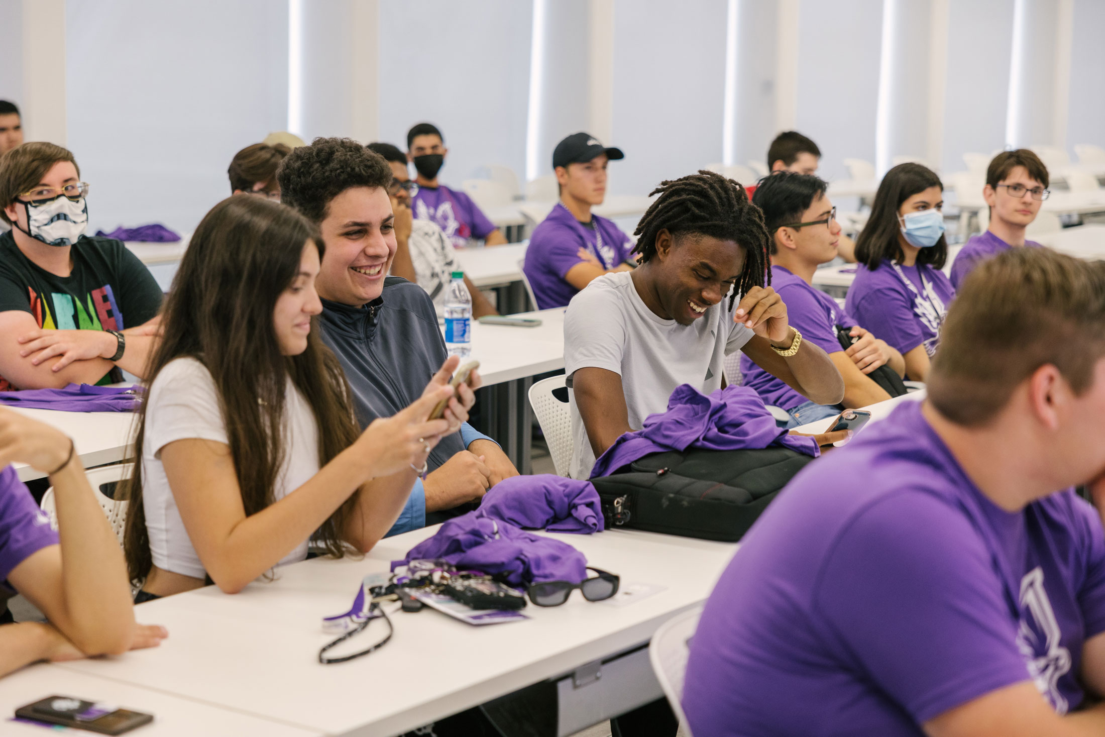 Florida Polytechnic University students laugh in a classroom.