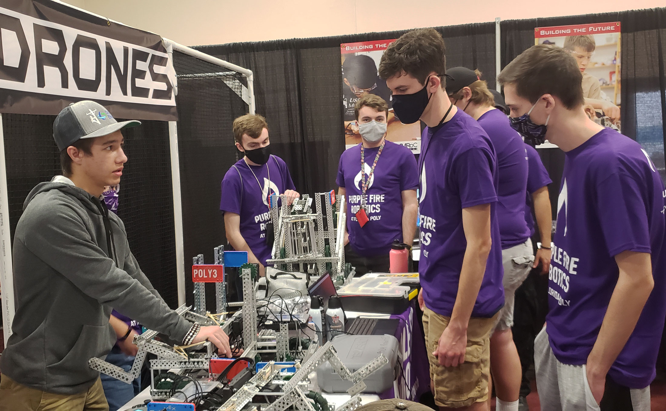 The Purple Fire Robotics team prepares their VEX U robots for a competition.