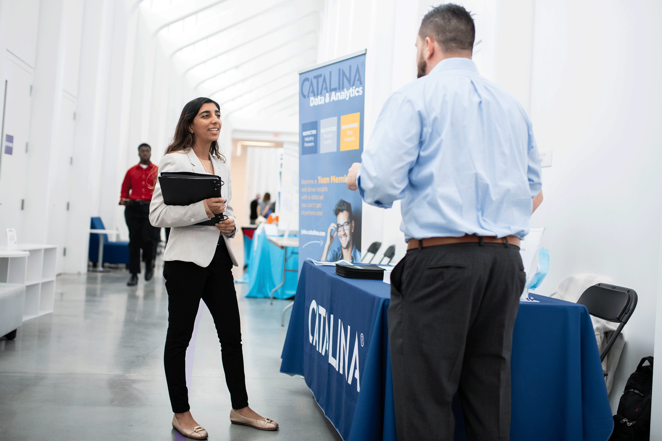 A student speaks to a company representative during Florida Poly's Career and Internship Fair.