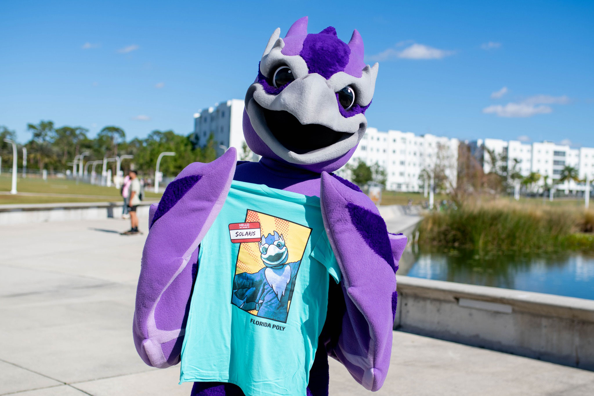 Solaris, the Florida Poly phoenix mascot, shows off a T-shirt with its likeness at a recent event to unveil its name.