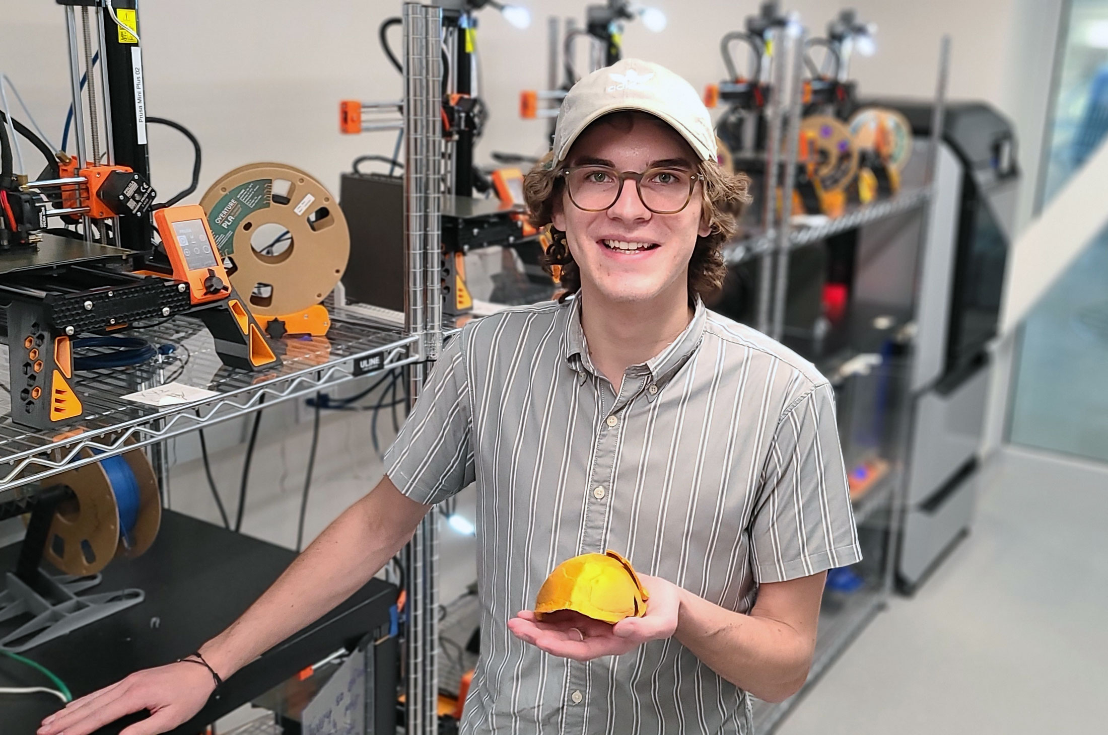 Matthew DeCicco displays a turtle shell he 3D printed.