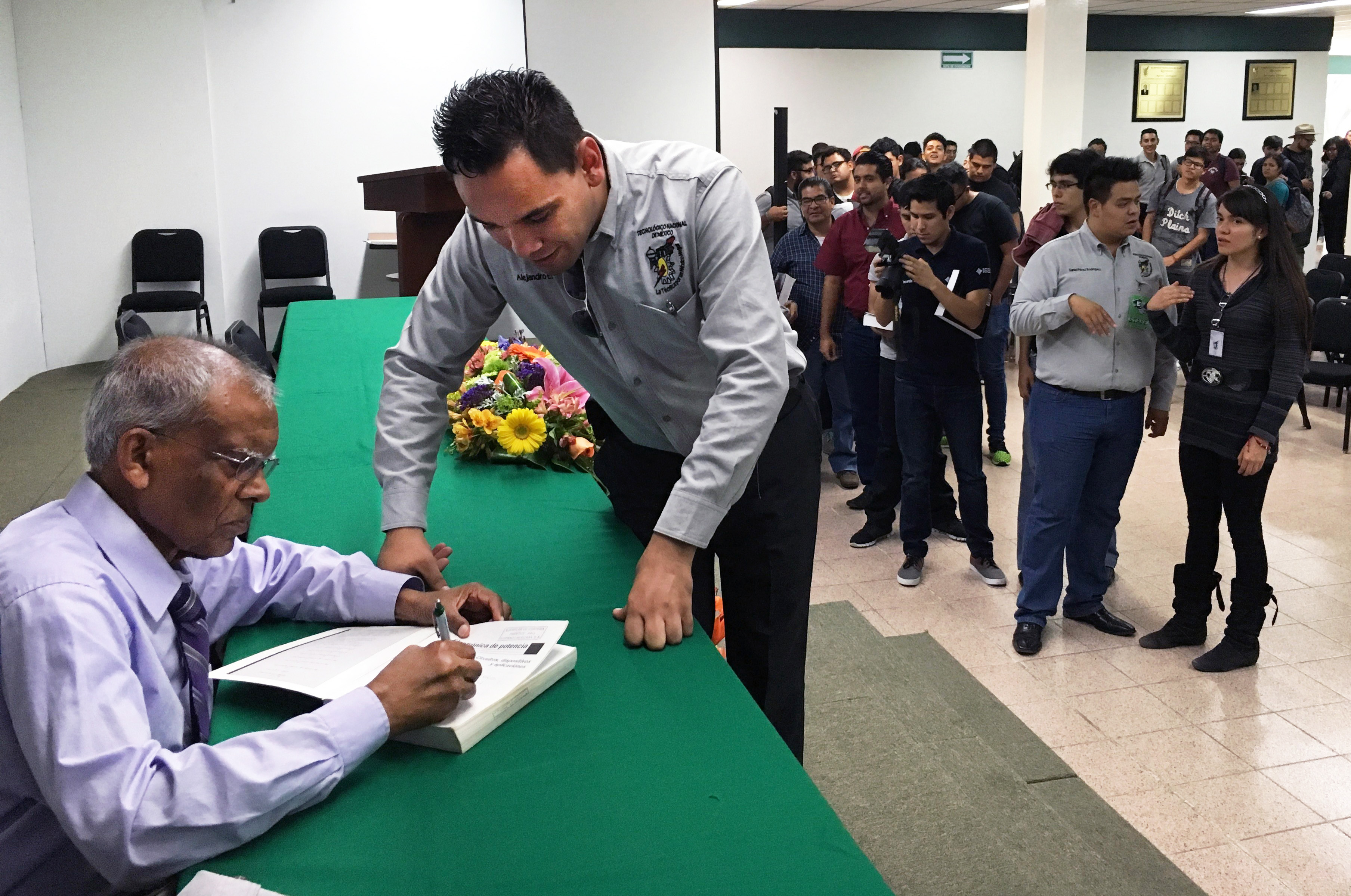 Dr. Muhammad Rashid signs autographs.