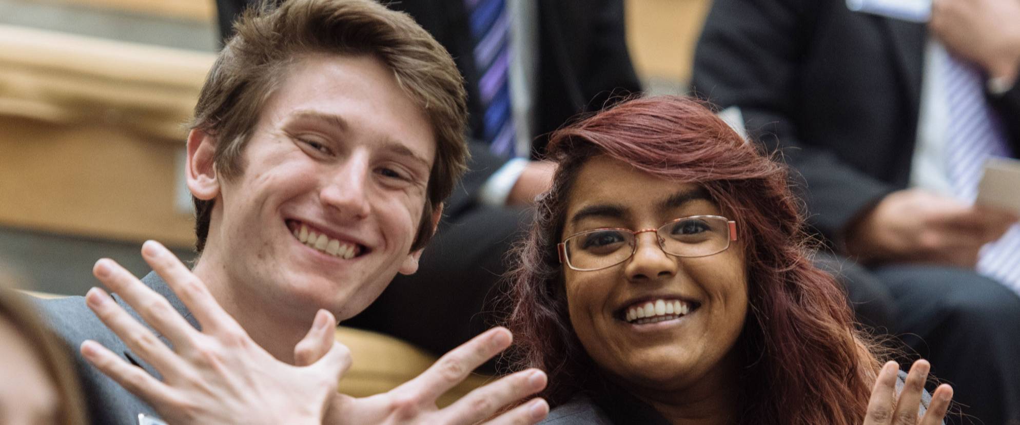 students holding up phoenix hands