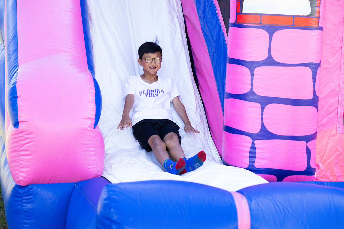 kid going down inflatable slide