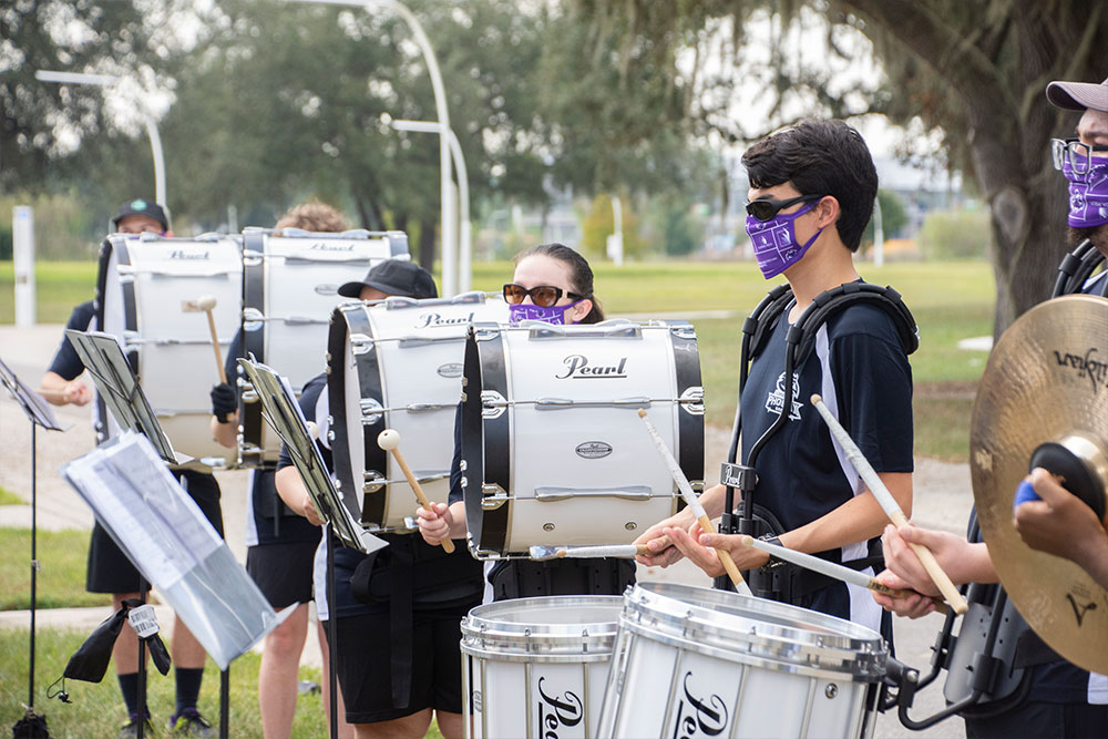 band member walking with purple shirt