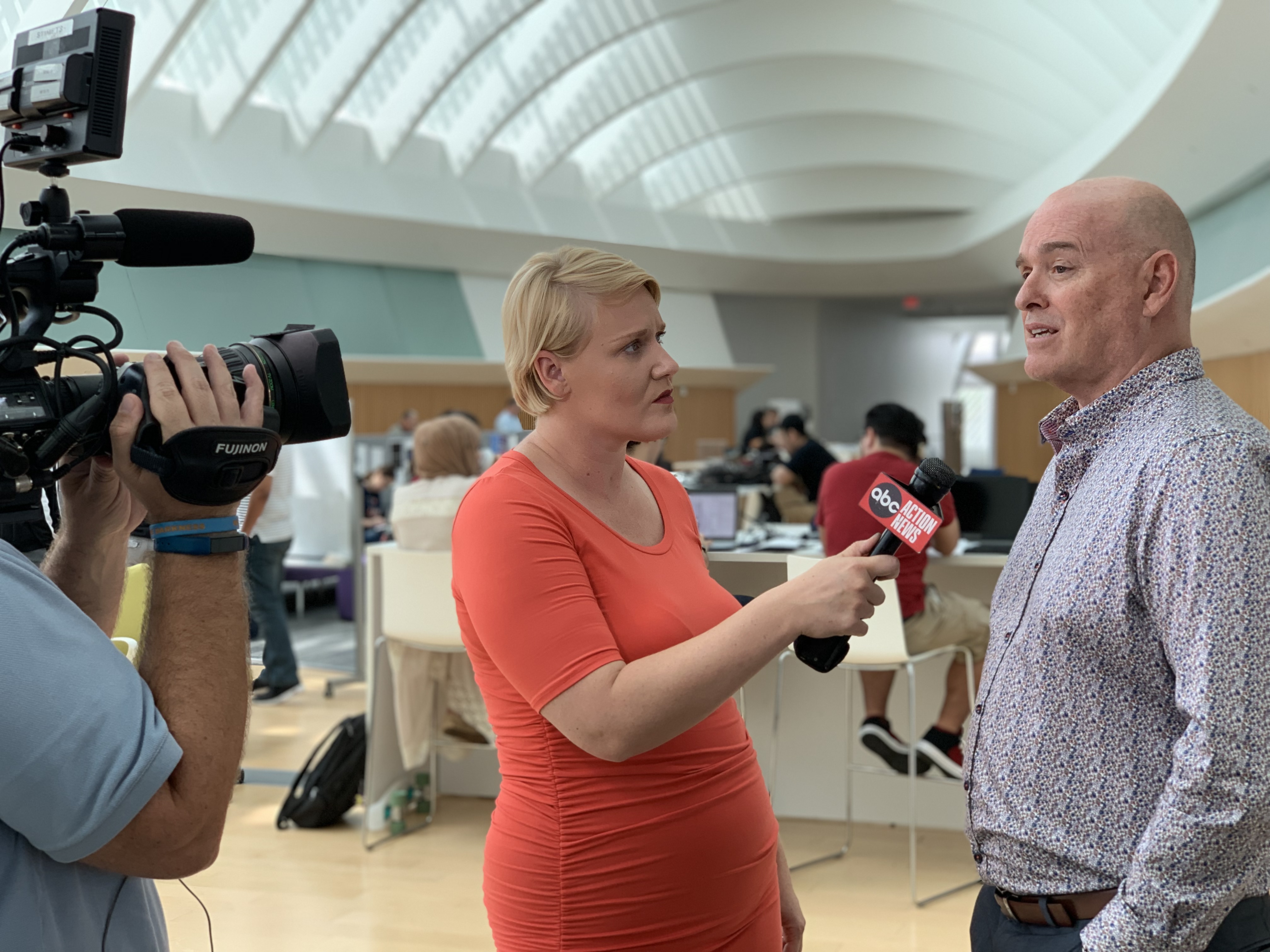 a reporter interviewing a faculty member