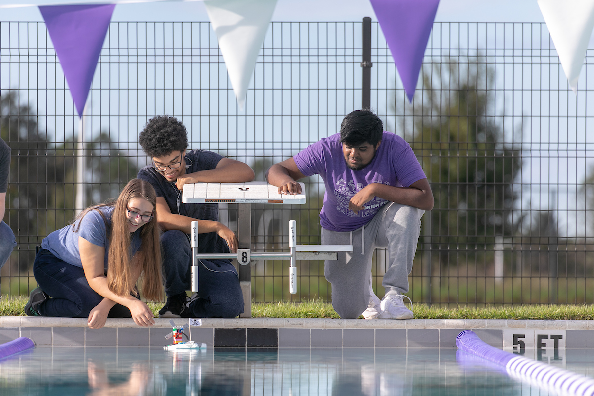 Students working on a project at the pool