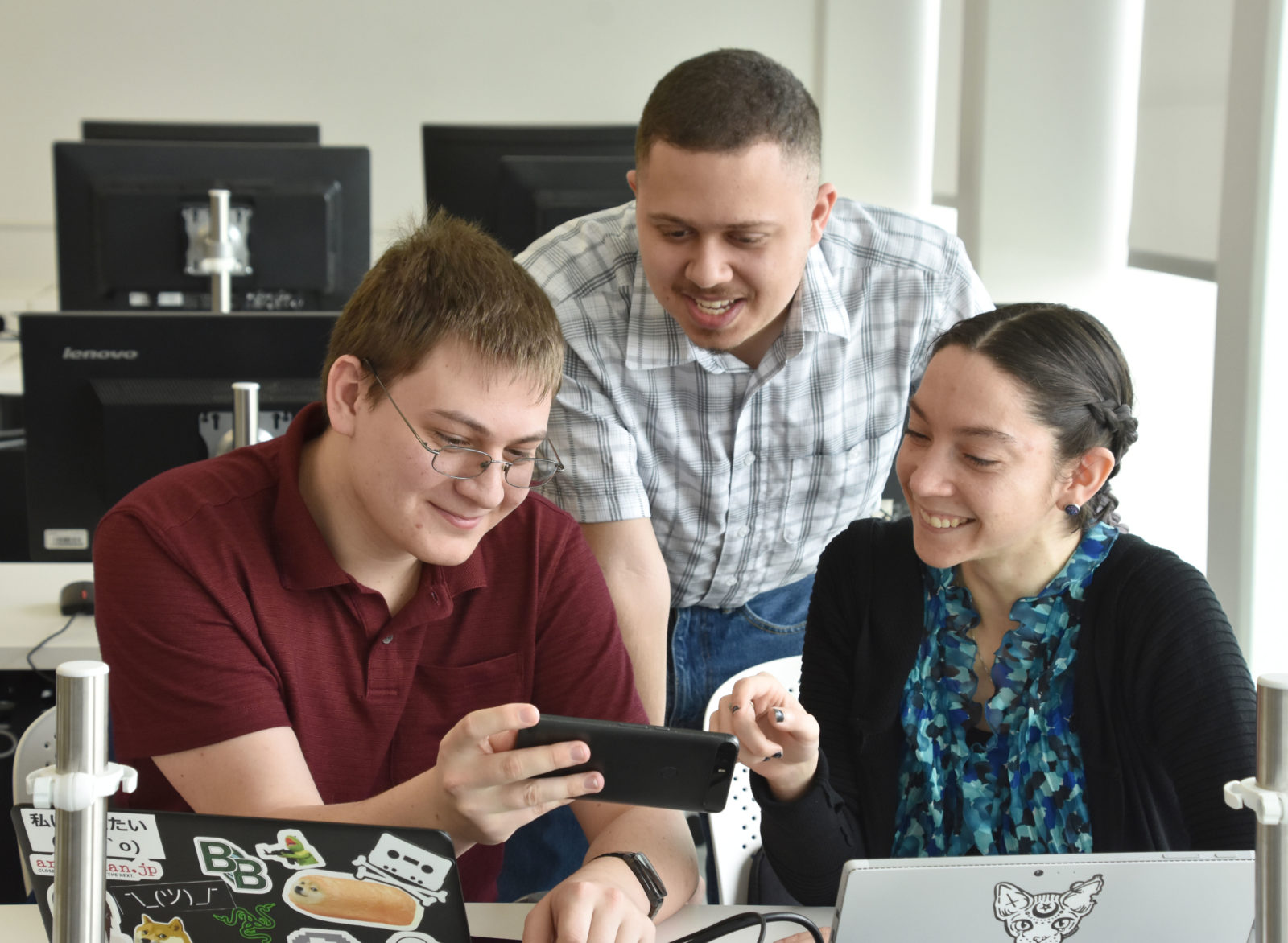 Three students work on Ogio app project