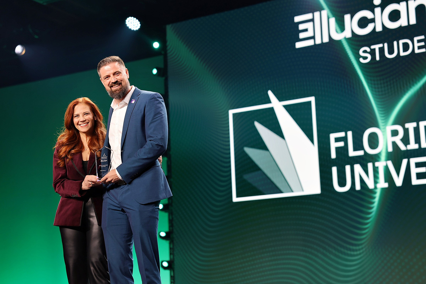 Florida Poly VP Cole Allen receives 2026 Ellucian Impact Award from Ellucian executive Christi Segal.