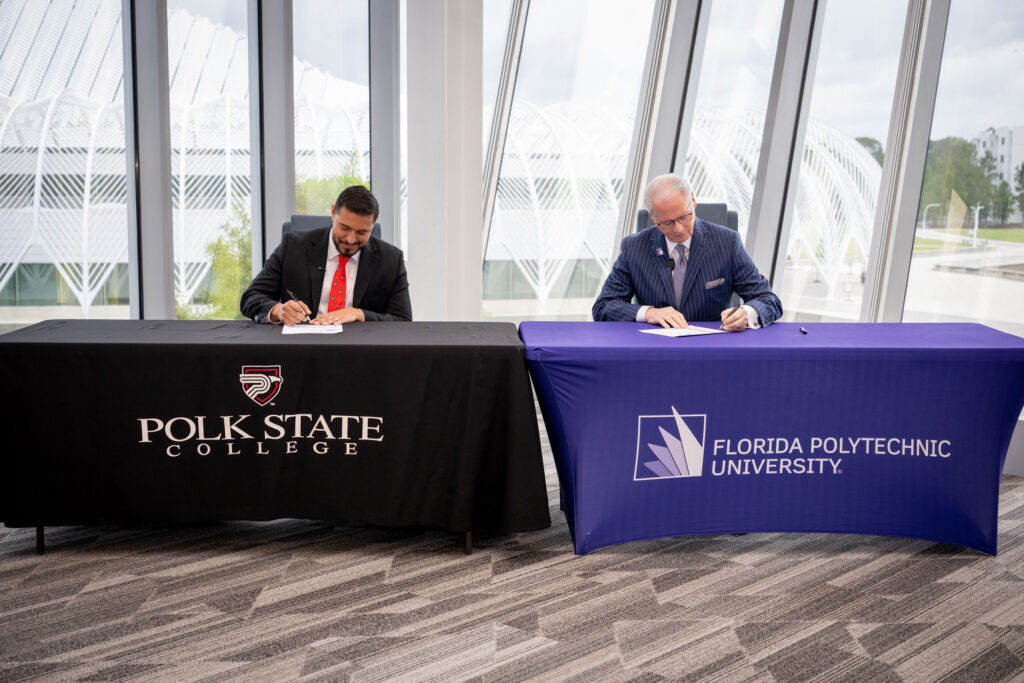 Polk State College President Anastasios Kamoutsas and Florida Polytechnic University President Devin Stephenson sign a partnership agreement establishing the Eagle to Phoenix Pathway program.