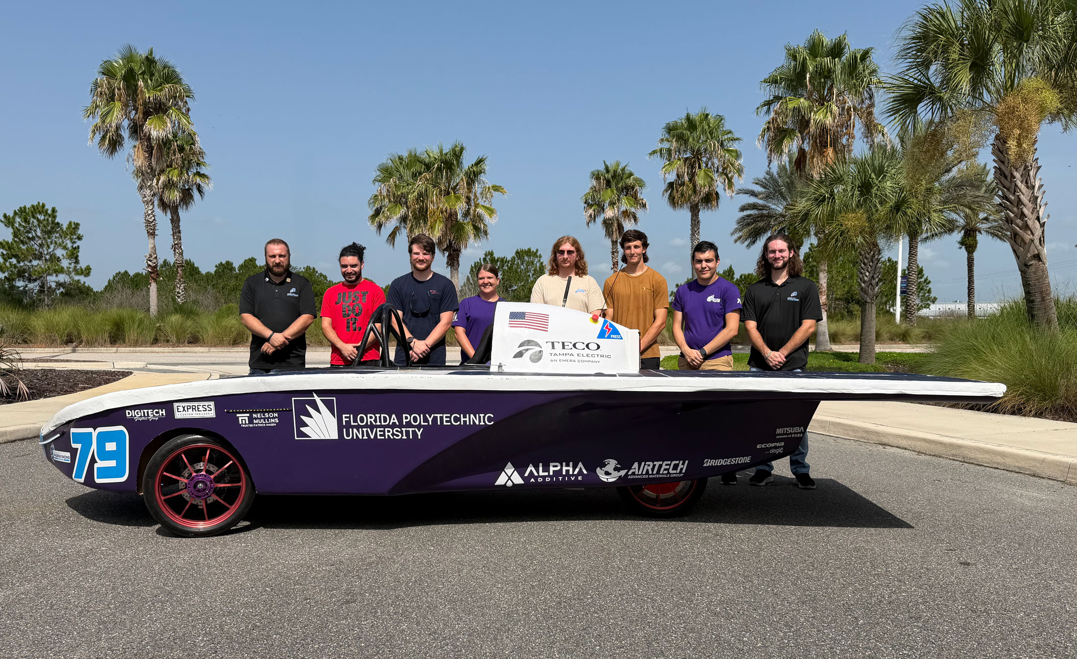 Phoenix Racing, Florida Poly’s solar racing team, stands with Spark MK 2.5, their new solar vehicle. They will compete in two national events this month, including the Electrek American Solar Challenge.