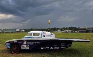 Spark MK 2.5 solar vehicle under gray skies, part of the challenging weather conditions during the race.