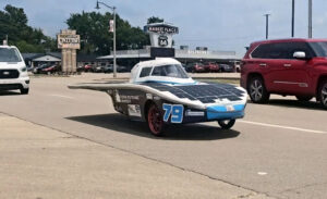 Phoenix Racing's Spark MK 2.5 solar vehicle navigates traffic during the cross-country Electrek American Solar Challenge race.