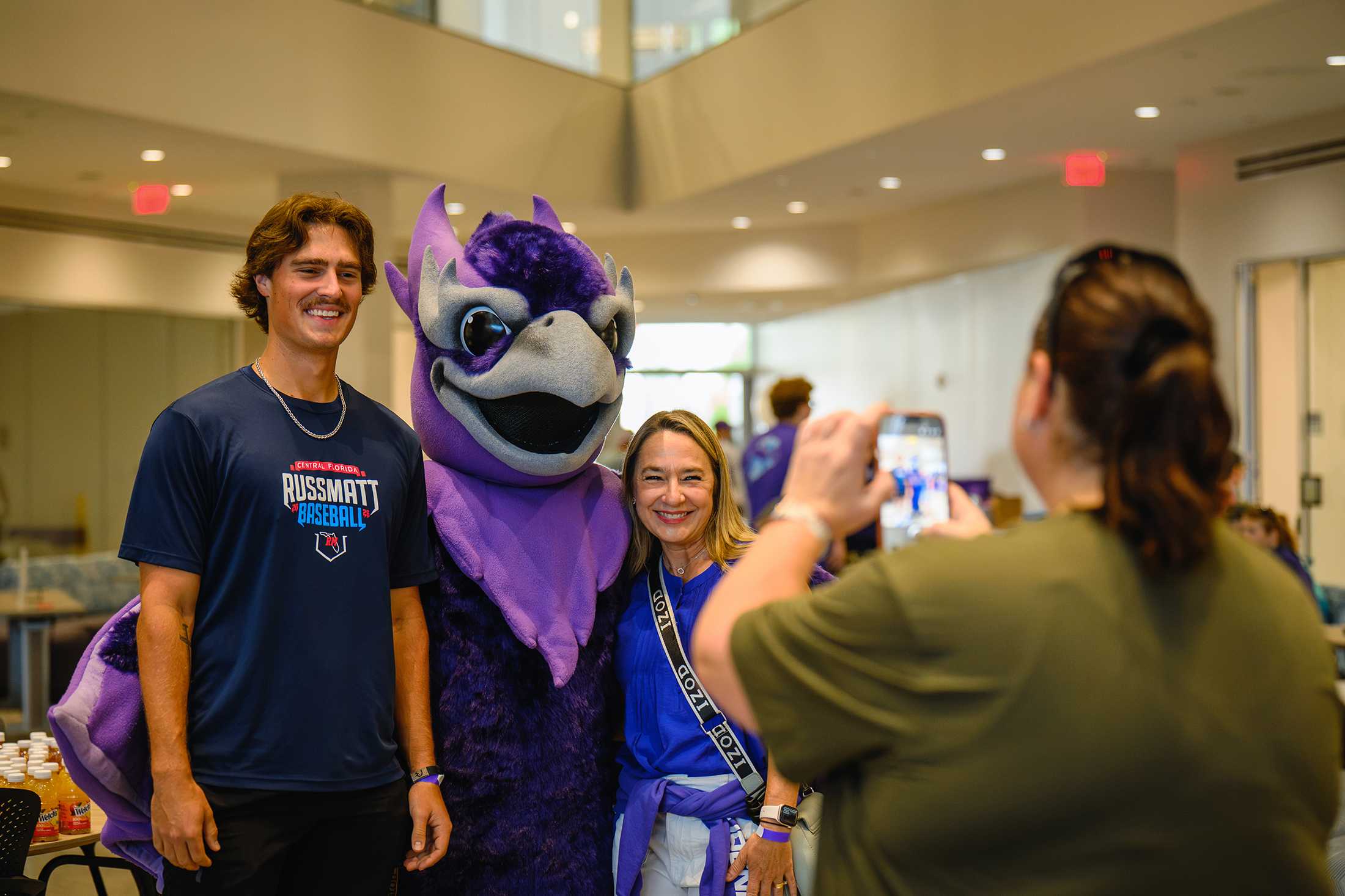 Student Hugh Cyhowski and his mother, Sarah , pose for a photo with Solaris, Florida Poly’s mascot at Phoenix Family Day.