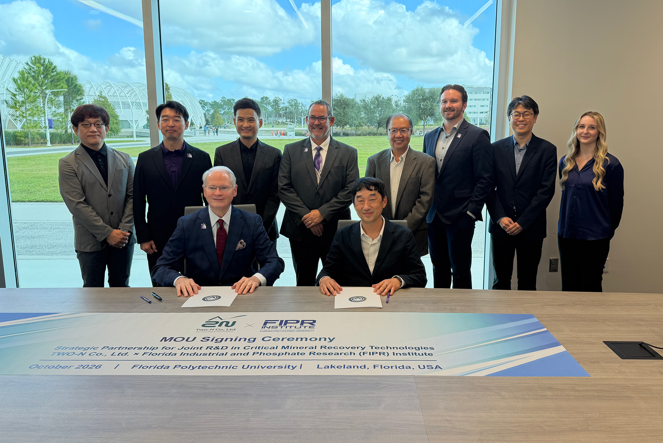 Florida Poly President Dr. Devin Stephenson (seated, left) and Two-N Co., Ltd. CEO Jaehun Kim, sign a memorandum of understanding to partner on recovering critical minerals from phosphate mining wastewater.