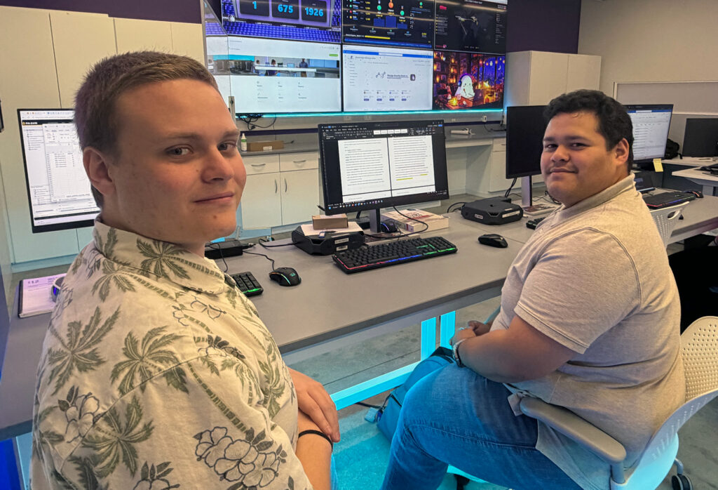 Colton Hewell (left) and Josh Morales work at Florida Poly's student-operated SOC.