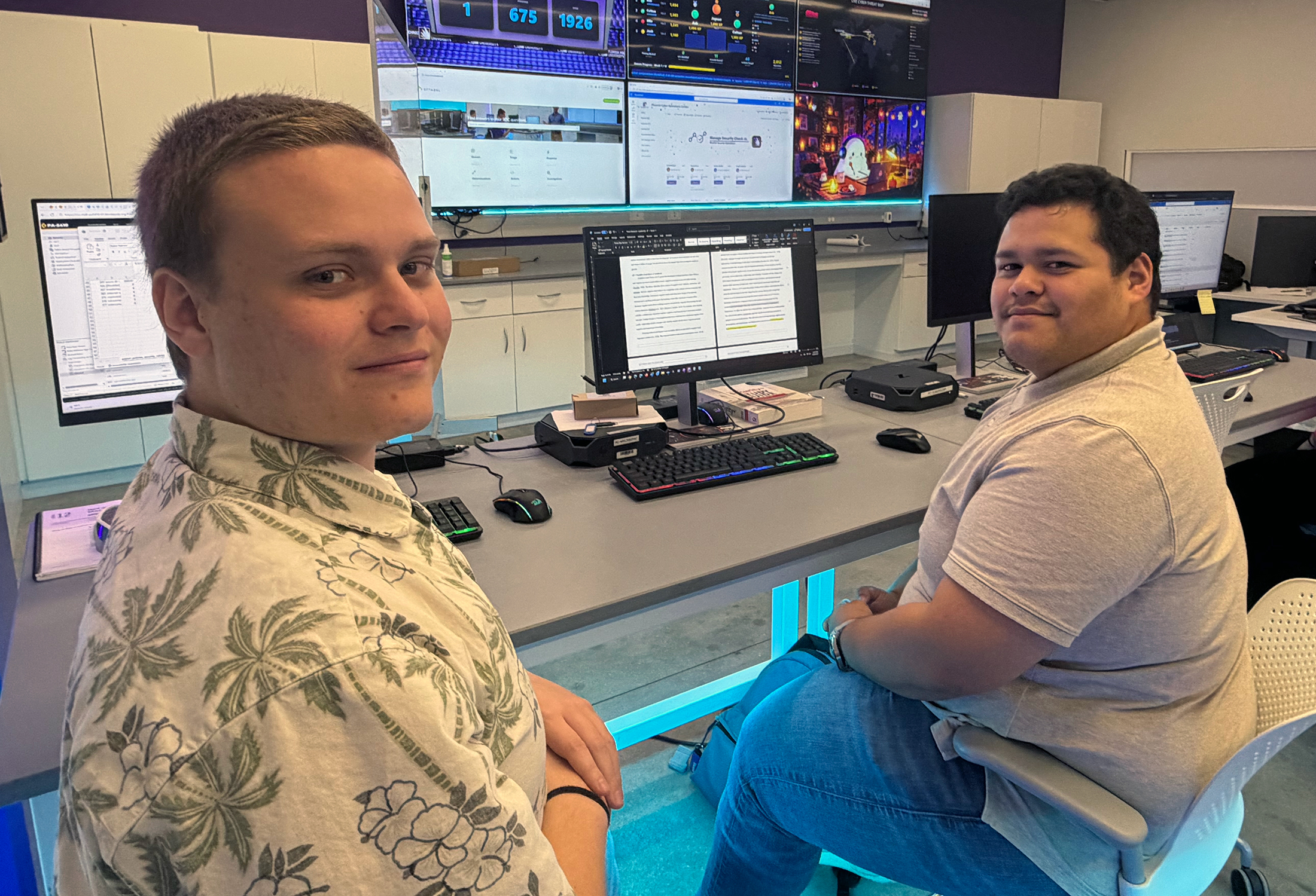 Colton Hewell (left) and Josh Morales work at Florida Poly's student-operated SOC.