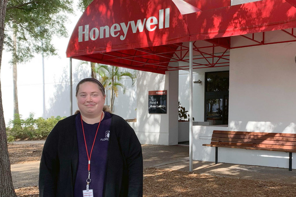 Light skinned women standing infront of Honeywell business sign