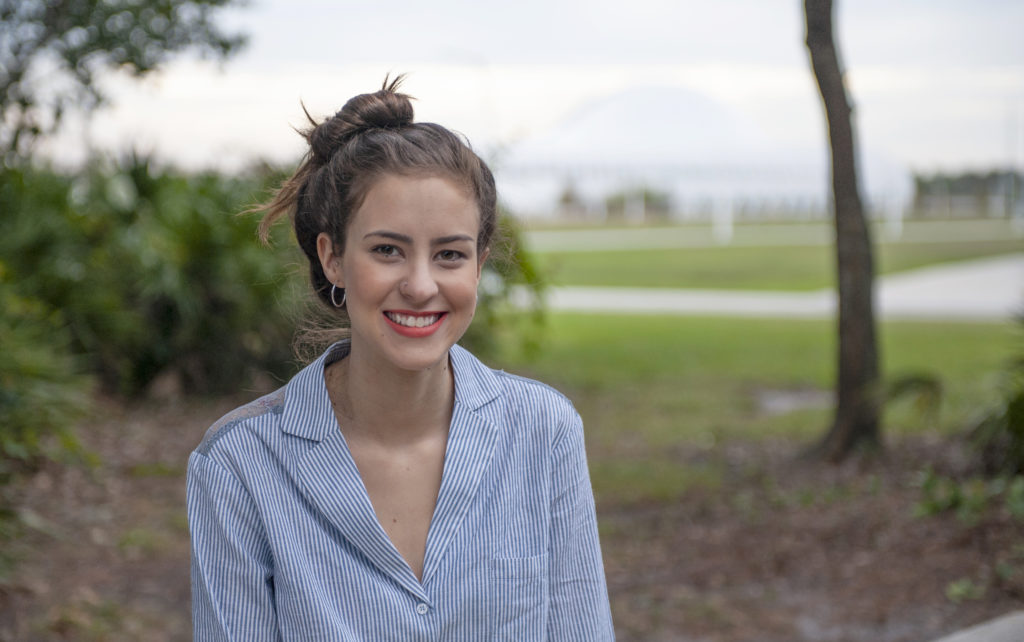 Florida Poly female student outside of wellness center.