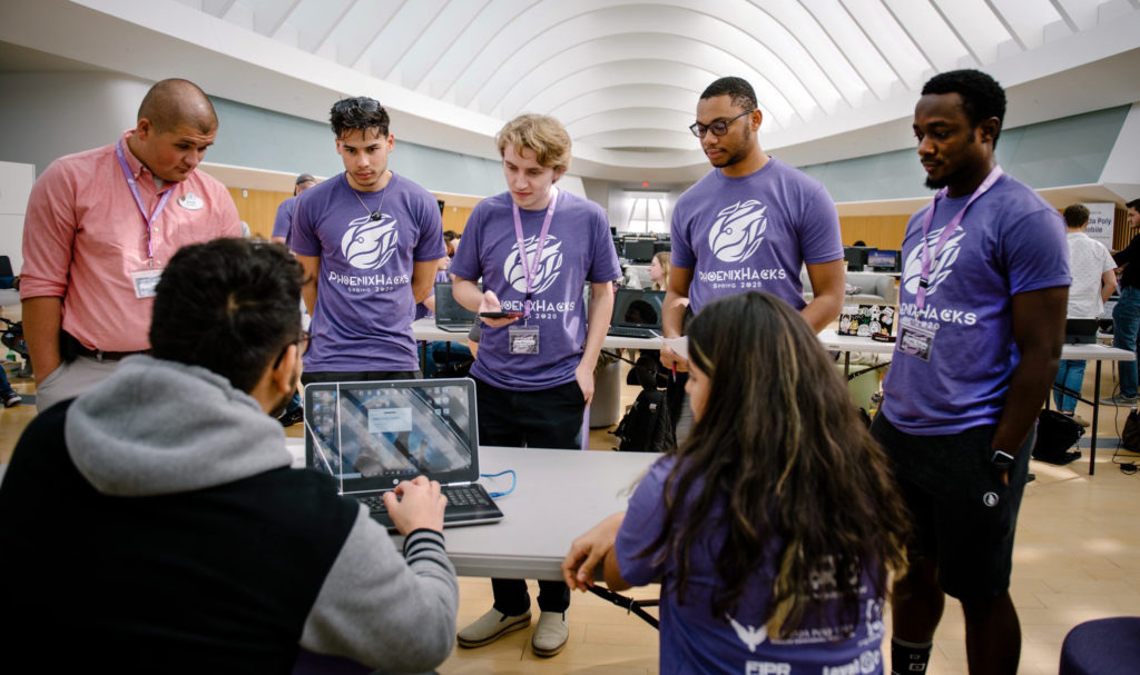 Judges learn about one of the student-created projects during PhoenixHacks, a hackathon that challenged Florida Polytechnic University students to create a software or hardware project in 24 hours.