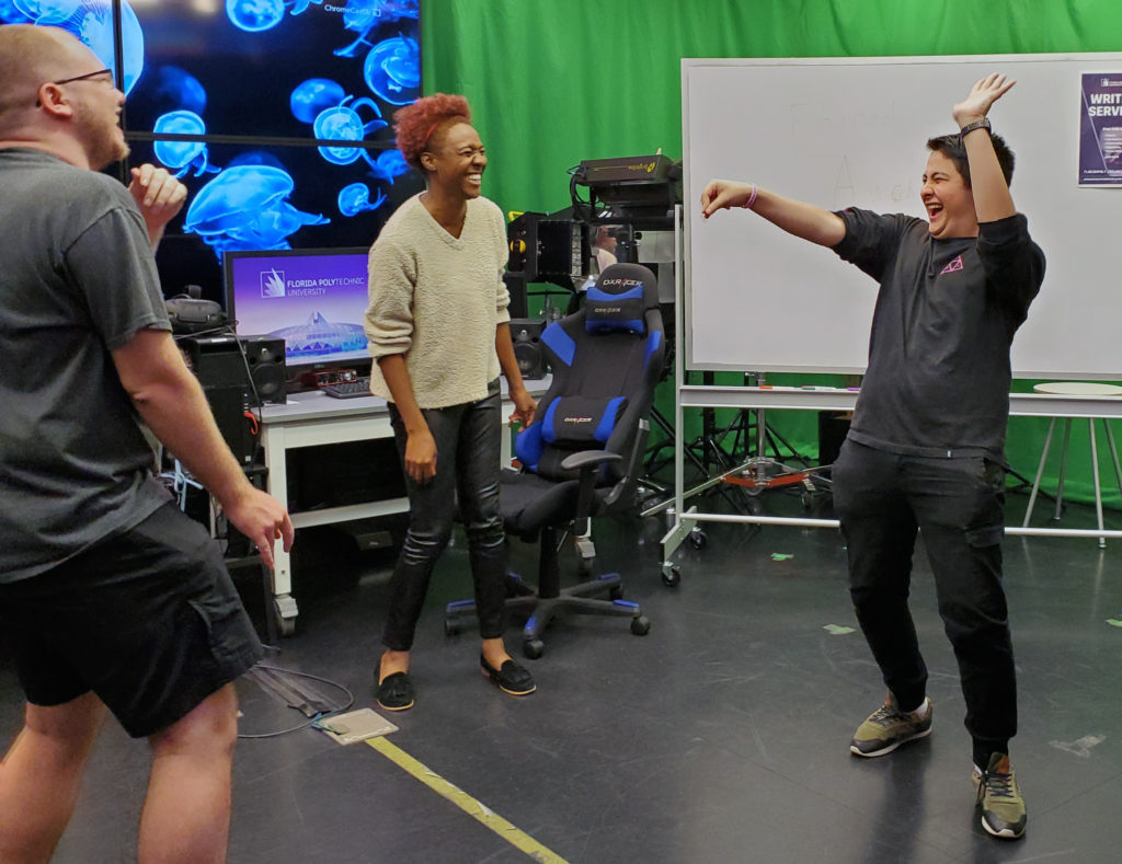 Florida Polytechnic University students Andrew Crosswait, left, Taryn Jones, and Ezekiel Huynh warm up during a recent meeting of student improv group The Baked Bean Bois.