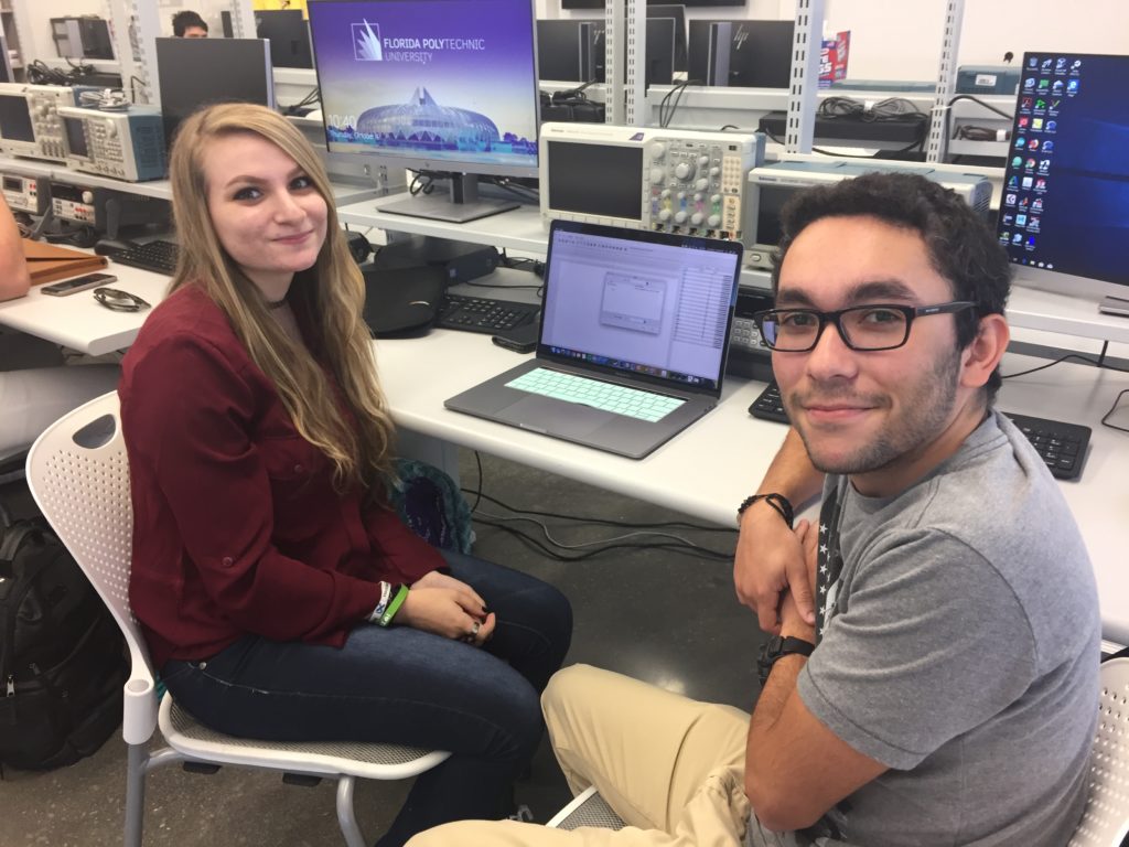 Two students at Florida Poly sitting in front of a computer