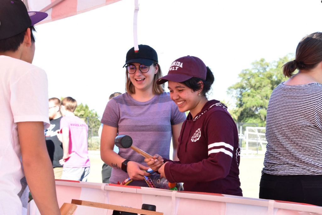 Two female Florida Poly student playing carnival games at Spirit Week.