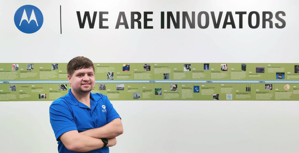 Light skinned male standing in front of Motorla sign that says we are innovators.