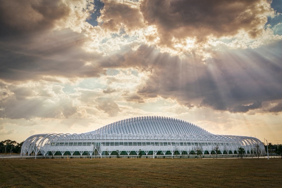 Sun flows through clouds over Innovation, Science, and Technology Building