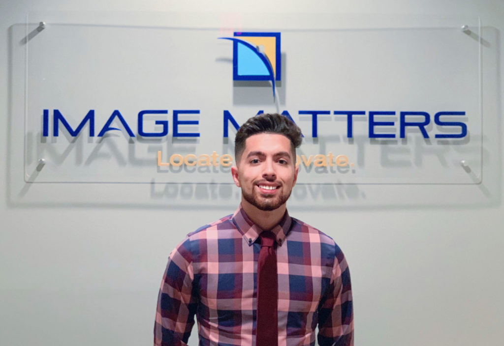 Light skinned male in front of Image Matters sign.