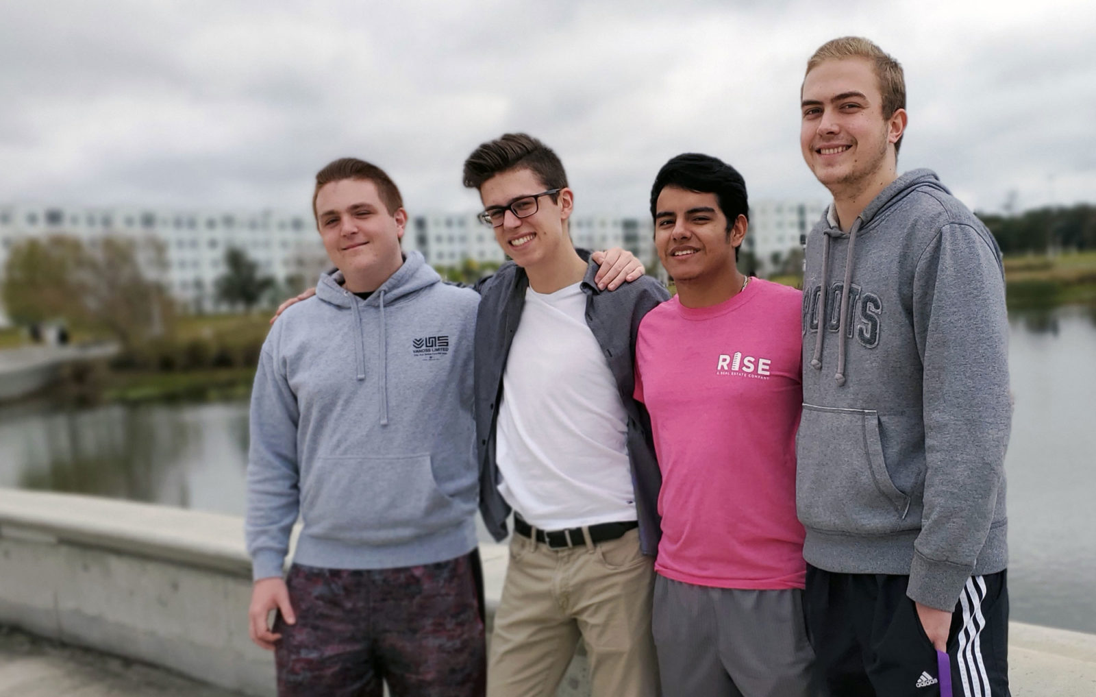 Four male students standing outside.