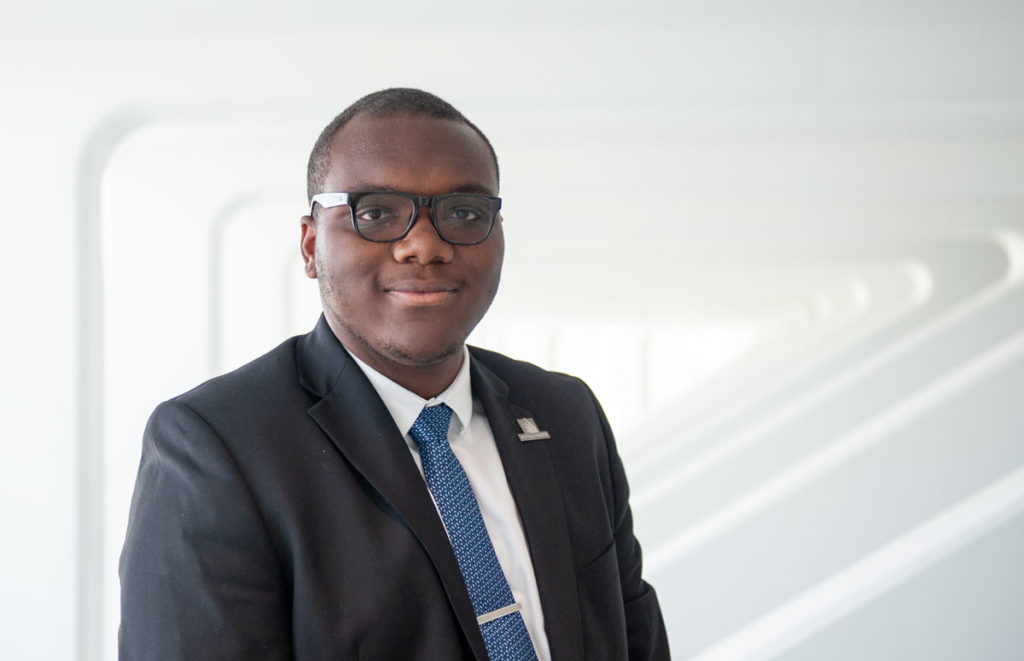 Dark skinned male standing.